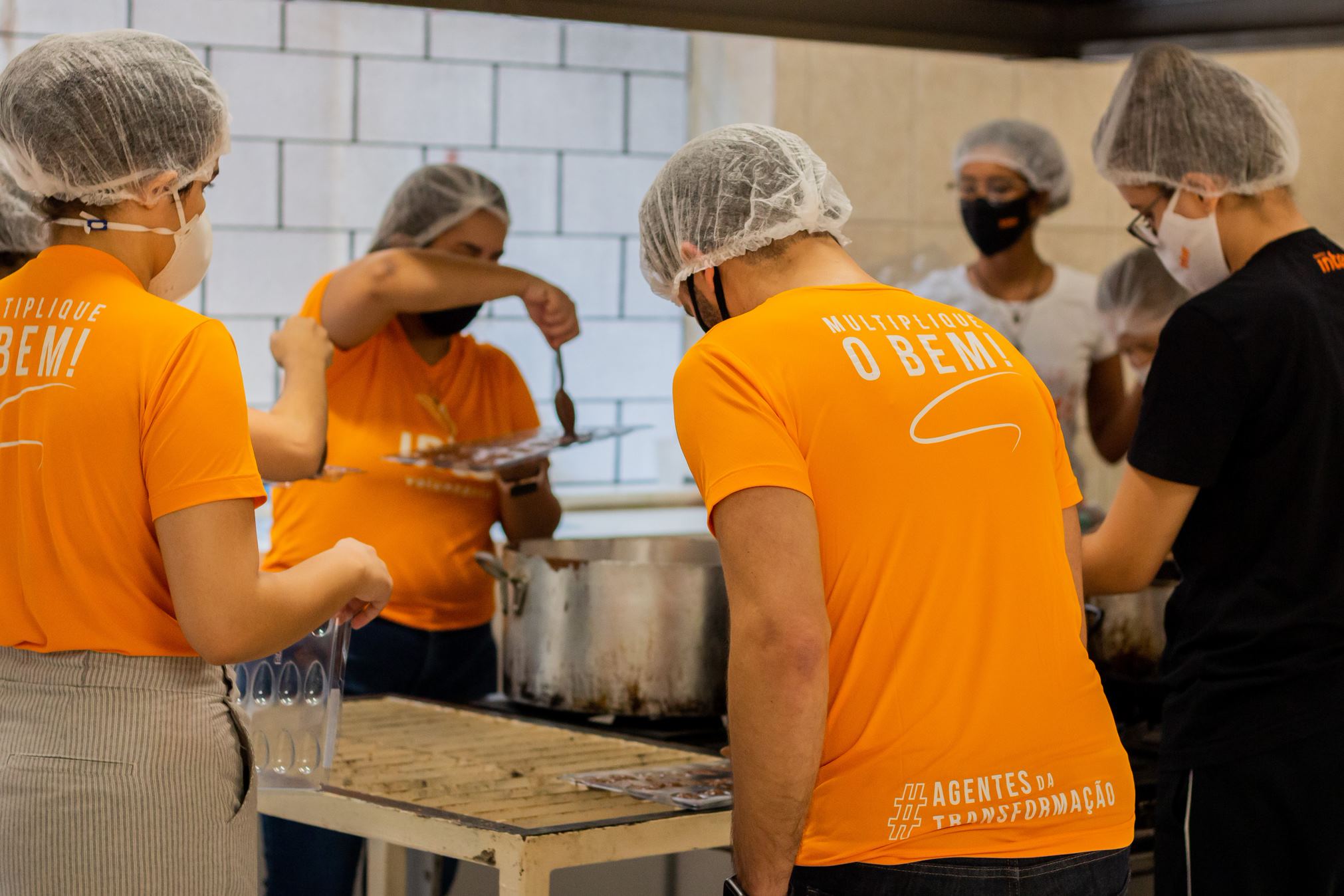Colaboradores preparando chocolate em uma ação do Inter Voluntariado